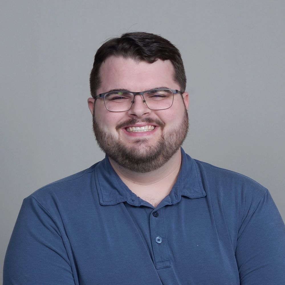 A photo of Wesley Bolton wearing a blue polo shirt.